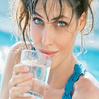 woman enjoying water from alkalizer